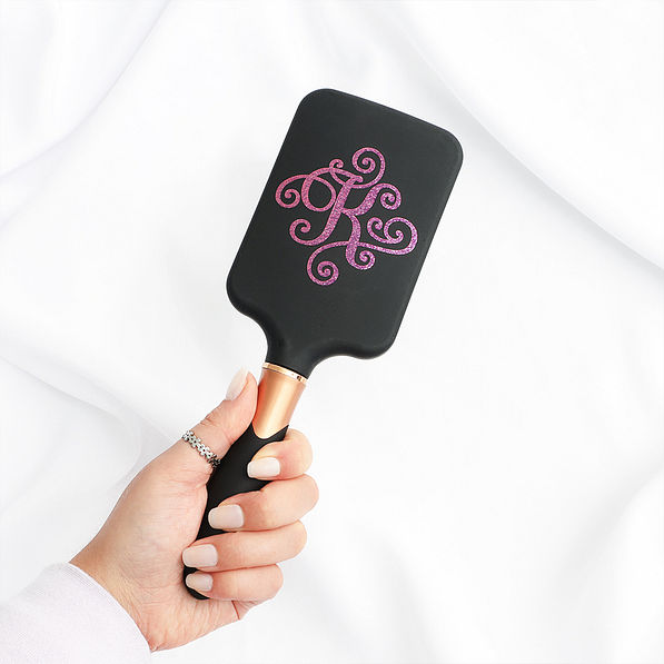 black hairbrush in hand