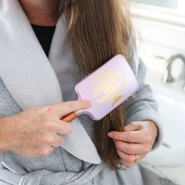 lavender hairbrush in dark hair