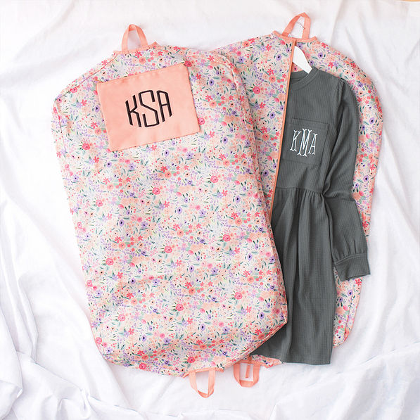 coral floral garment bag flatlay
