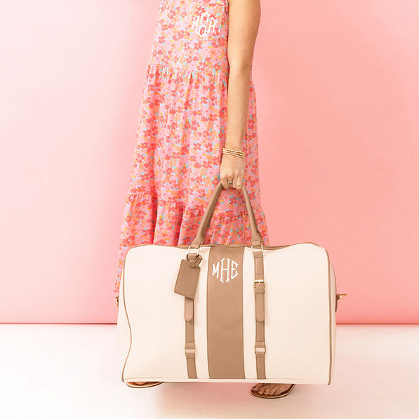 ivory weekender bag in hand with dress