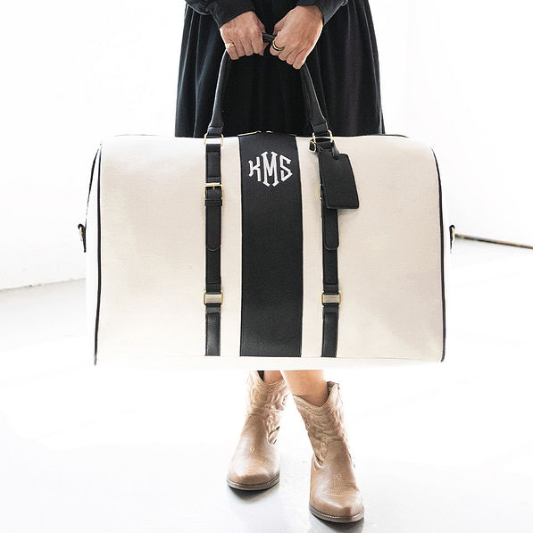 ivory/black weekender bag in hand