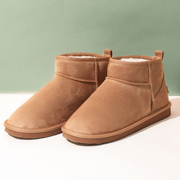 sherpa ankle booties on green and white background