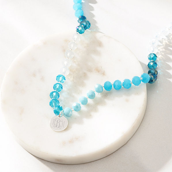 blue beaded necklace with marble dish