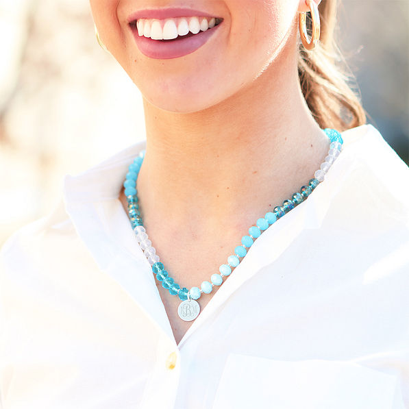 blue beaded necklace with white button down