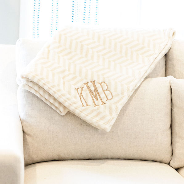 neutral herringbone plush blanket on couch