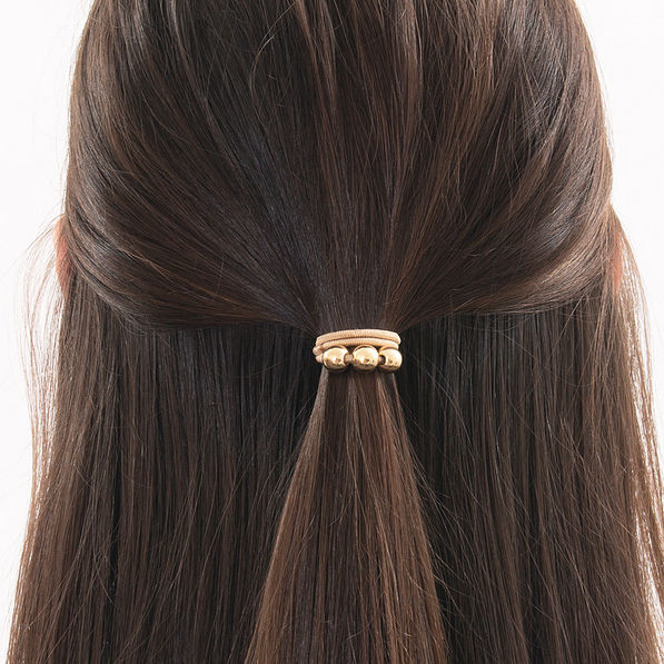 gold hair tie in hair