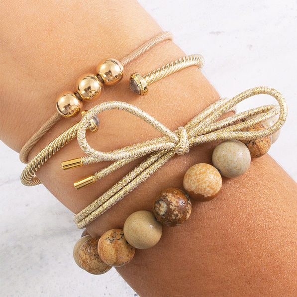 tan and gold hair ties on wrist