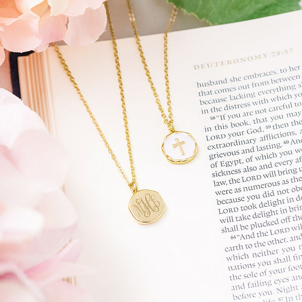 white monogrammed reversible cross necklace front and back on bible