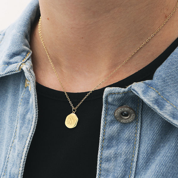 reversible cross gold monogrammed necklace around neck