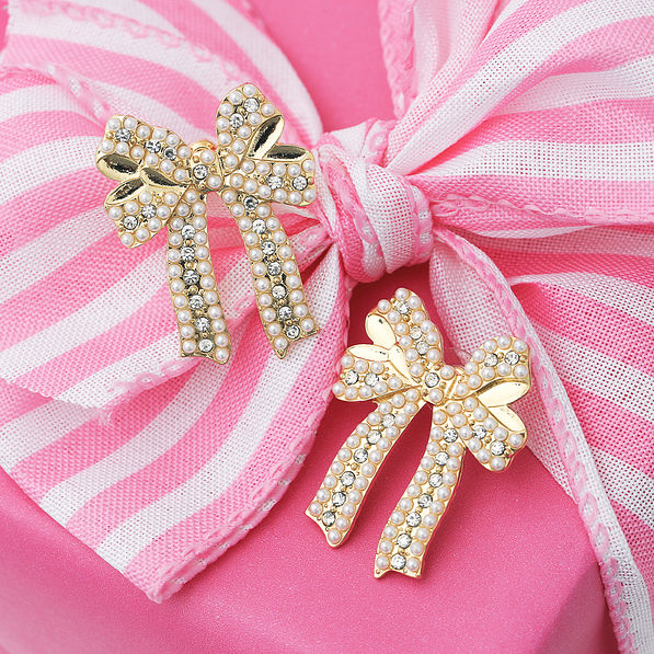 pearl bow earrings on pink present