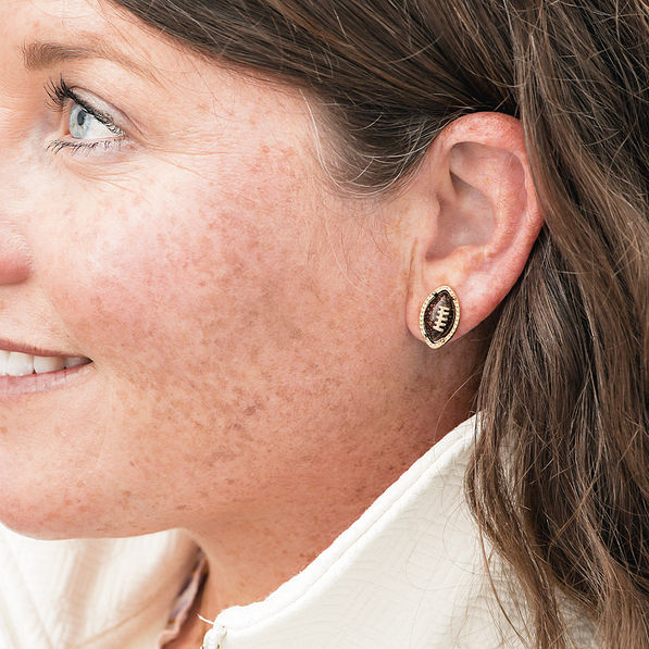 football earrings in ear