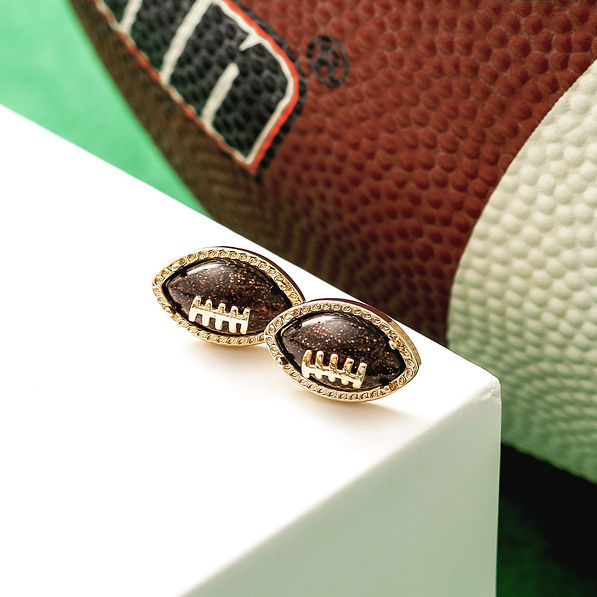 football earrings with football in background