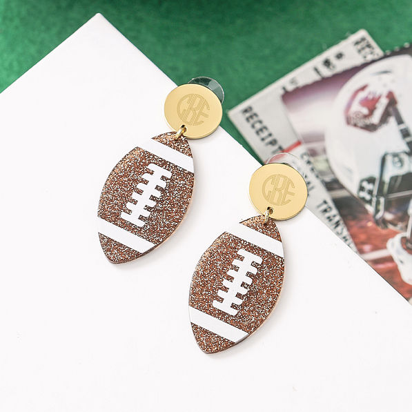personalized football earrings on turf