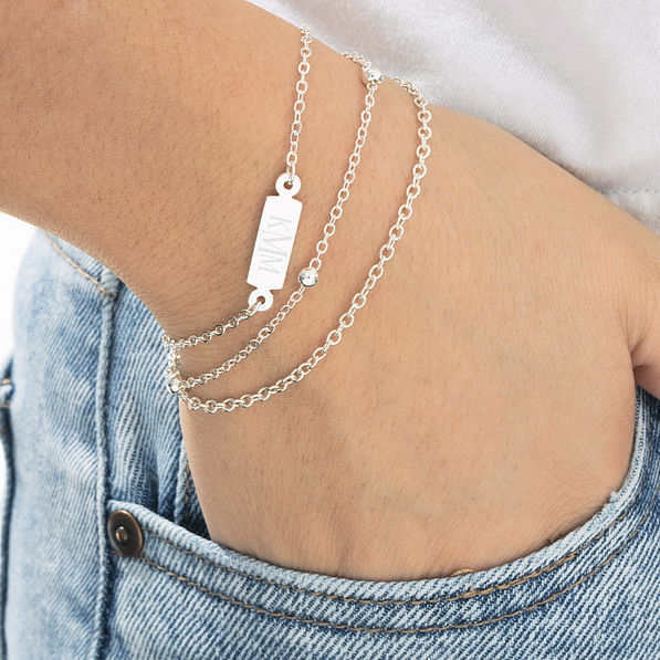 monogrammed silver multistrand bracelet on wrist
