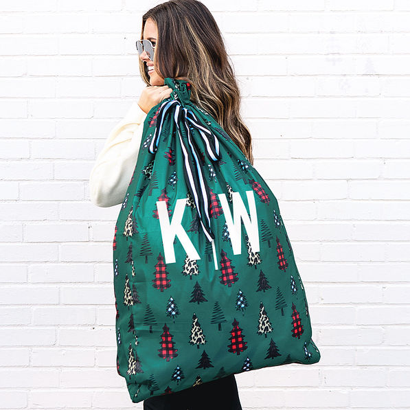 monogrammed gift sack in festive forest over the shoulder