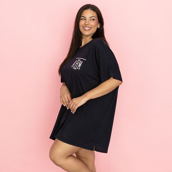 monogrammed sleep tee on model in front of pink paper