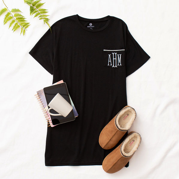 monogrammed sleep tee on white sheet with moccasins