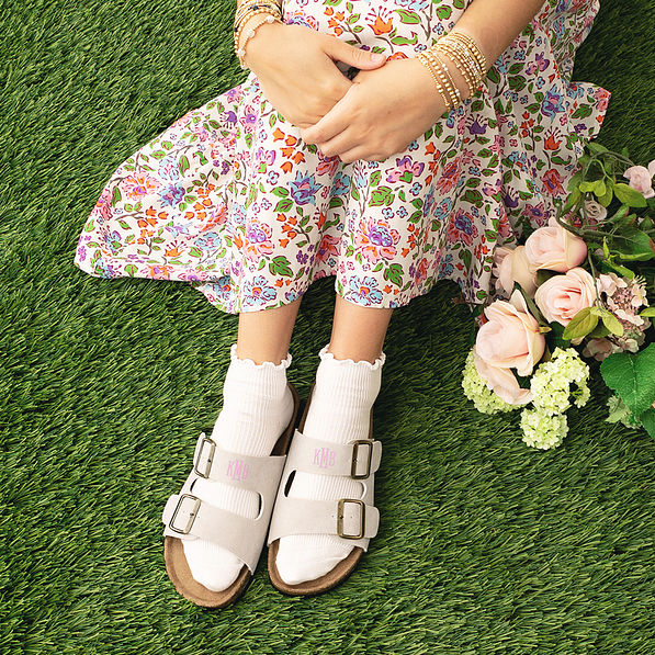 girl wearing monogrammed double strap sandals