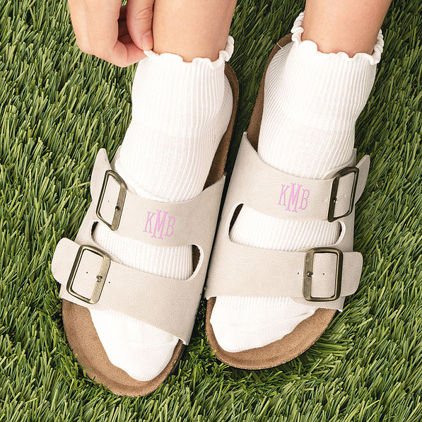 up close of girl wearing monogrammed double strap sandals