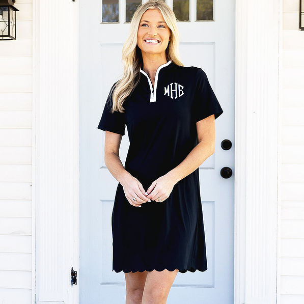 girl wearing monogrammed black quarter zip dress on porch