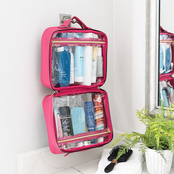 hot pink large clear toiletry case hanging up