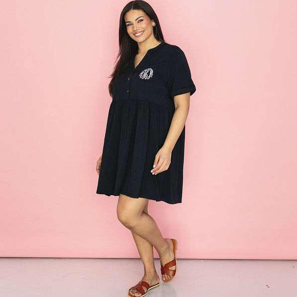 side of black split neck gathered monogrammed dress with sandals