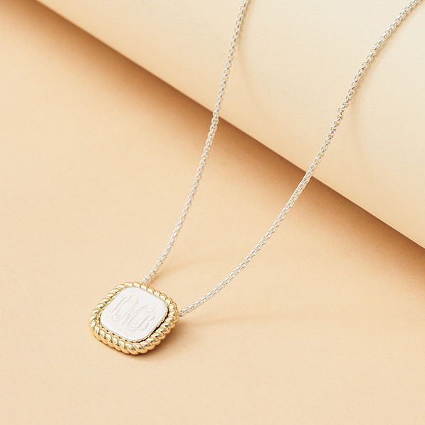 gold and silver cable pendant necklace with tan background