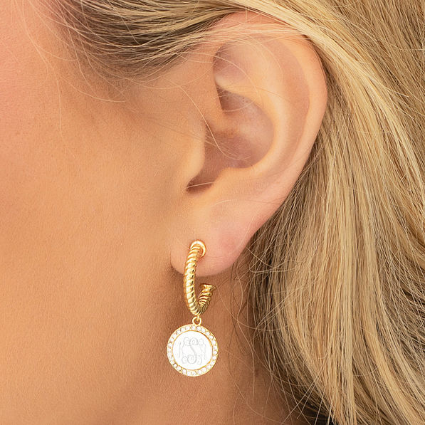 silver and gold cable hoop earrings in ear