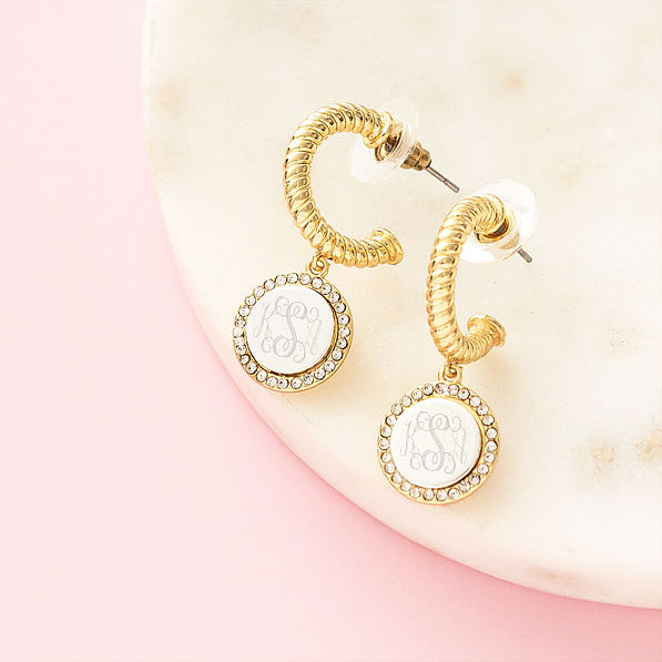 silver and gold cable hoop earrings on marble dish