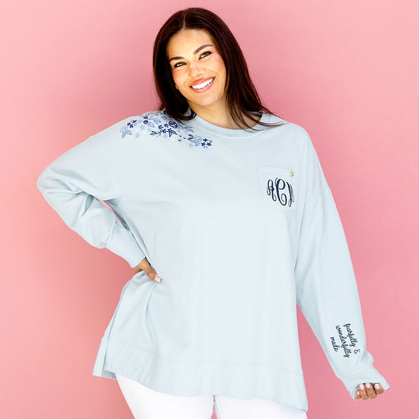 personalized ice blue faith sweatshirt in front of pink paper