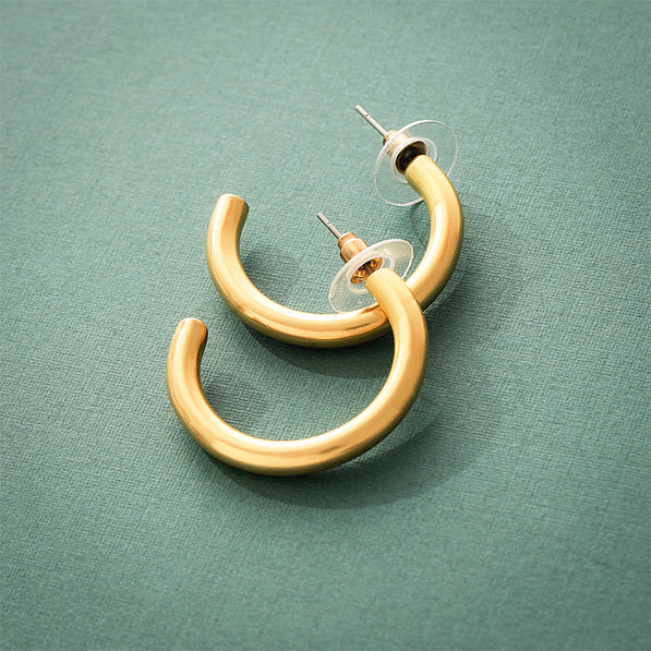 gold brush hoop earrings on green background stacked