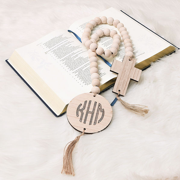 cross wooden bead engraved garland on bible