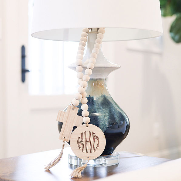 wooden cross monogrammed garland around lamp