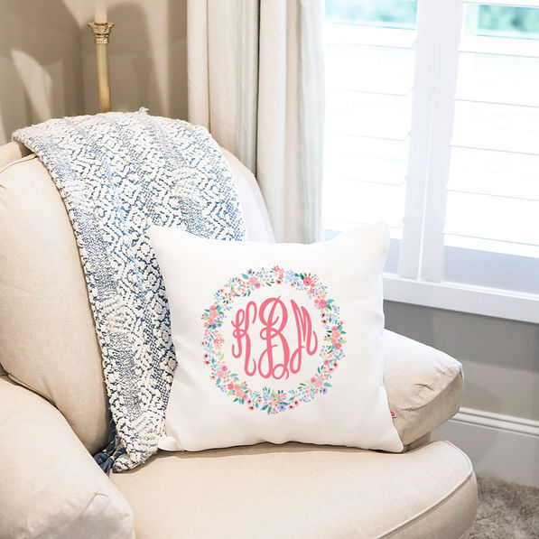 personalized pillow on chair with coral floral design