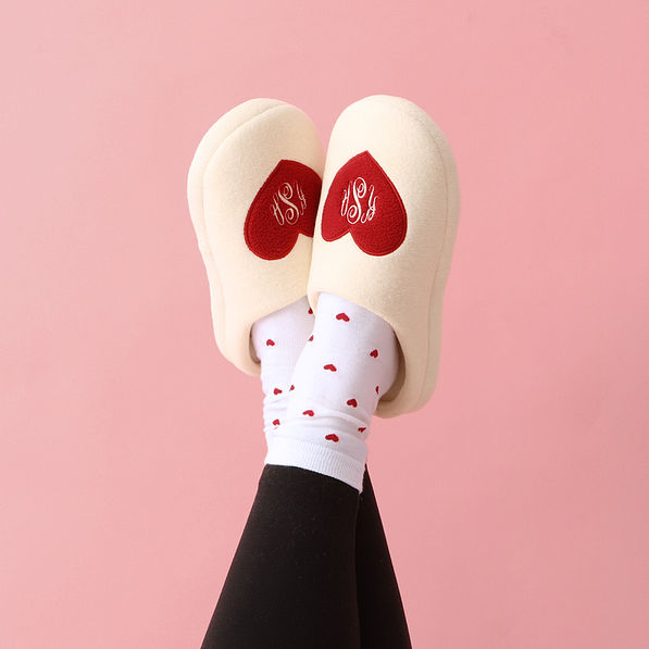 heart socks with monogrammed slippers and crossed ankles