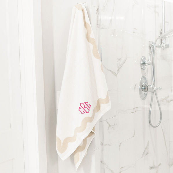 bath towel set on shower with pink octagonal monogram