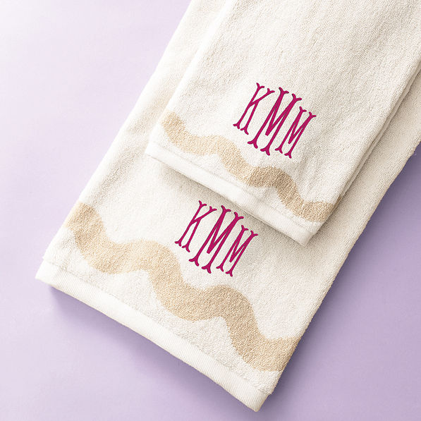 bath towel set on purple background with magenta fishtail monogram