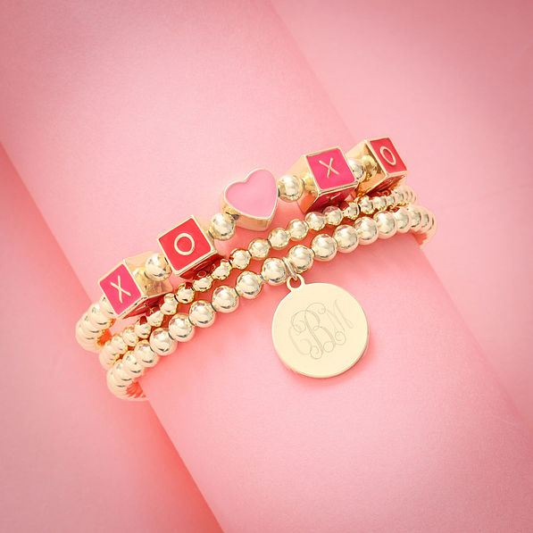 heart bracelet set on rolled pink paper
