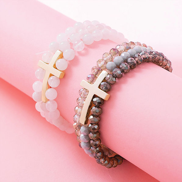 cross bracelet in taupe and white on pink