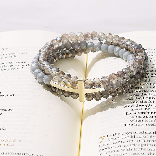 cross bracelet in taupe on bible