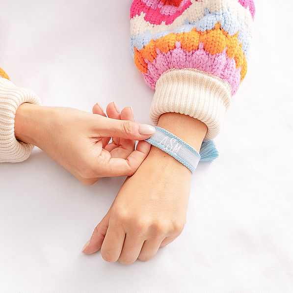 blue personalized woven bracelet on wrist