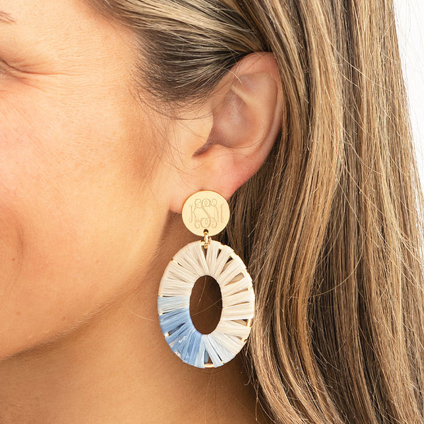 gray raffia earrings in ear