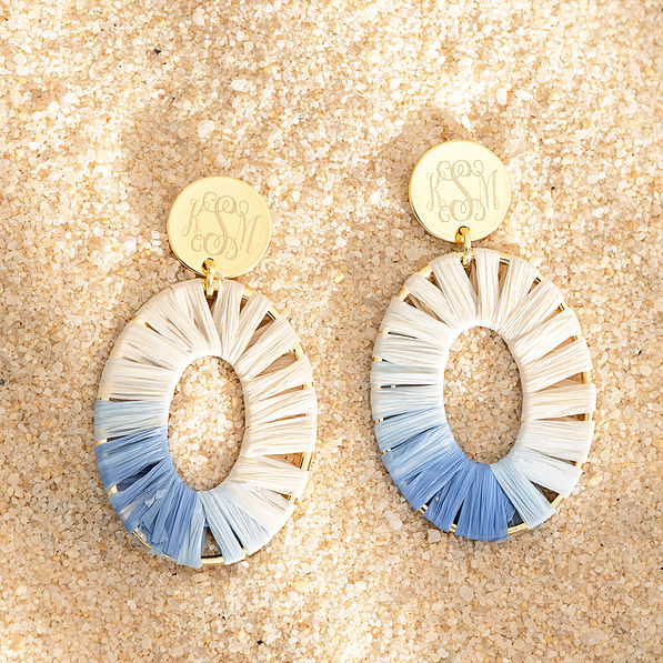 gray raffia earrings on sand