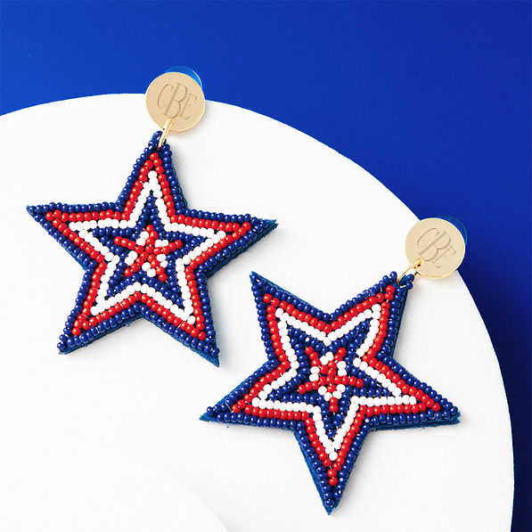 patriotic earrings on blue and white background