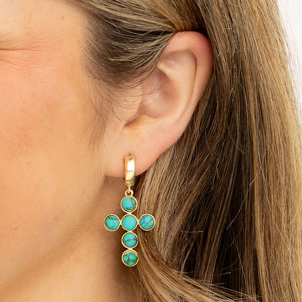 turquoise cross earrings in ear