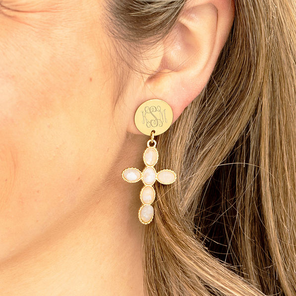 monogrammed cross earring in ear