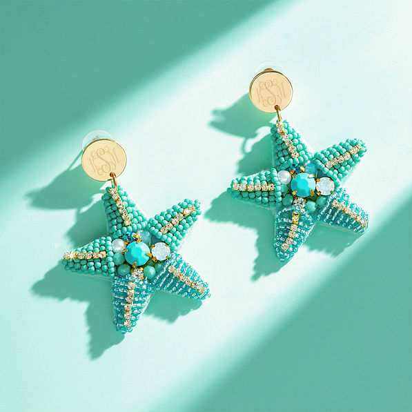 blue starfish earrings on blue green background