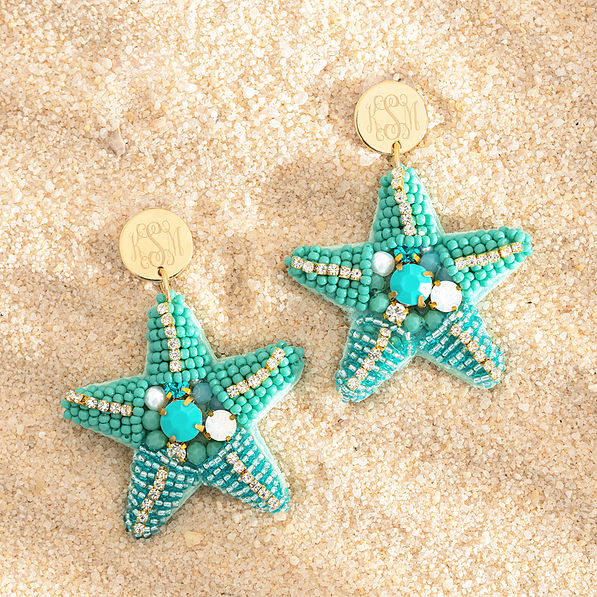 blue starfish earrings on sand