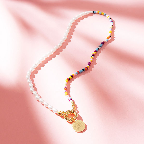 pearl seed bead necklace on print paper with shadows