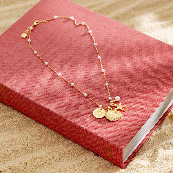 shell pearl necklace on book